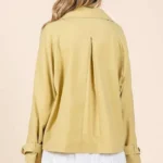 Back view of mittoshop double breasted trench coat jacket on model, showcasing tailored fit and classic longline silhouette