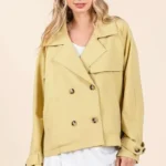 Detailed view of double breasted buttons and lapel on women’s mittoshop trench coat jacket