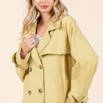 Detailed view of double breasted buttons and lapel on women’s mittoshop trench coat jacket