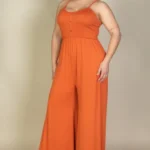 Side view of plus size button front jumpsuit highlighting the wide leg design, comfortable fit, and streamlined silhouette for a stylish and versatile outfit