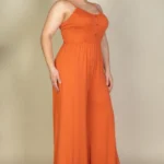 Side view of plus size button front jumpsuit highlighting the wide leg design, comfortable fit, and streamlined silhouette for a stylish and versatile outfit