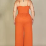Back view of plus size wide leg jumpsuit with a smooth, relaxed fit, showcasing a clean silhouette and flowing fabric for an elegant and flattering drape