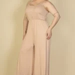 Side view of plus size button front jumpsuit highlighting the wide leg design, comfortable fit, and streamlined silhouette for a stylish and versatile outfit