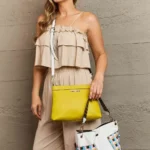 Model carrying Nicole Lee USA Quihn tote handbag and wearing matching crossbody bag, showcasing versatile 3-piece designer set for stylish everyday use