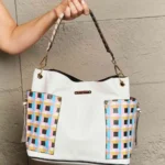 Model holding Nicole Lee USA Quihn tote handbag front view, showcasing structured design, dual handles, and stylish everyday fashion look