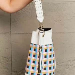 Side profile of Nicole Lee USA Quihn 3-piece handbag set highlighting spacious tote design and sleek crossbody bag silhouette